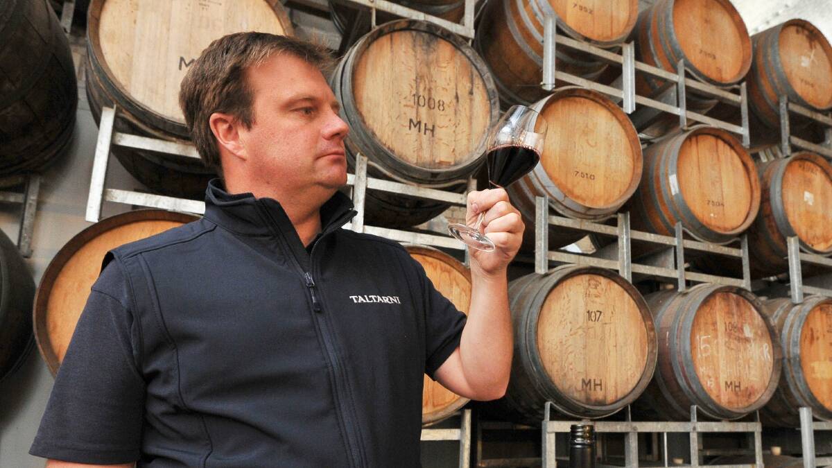 A good drop: Taltarni chief winemaker Robert Heywood inspects a glass of 2016 cabernet sauvignon at Mitchell Harris Wines. Picture: Lachlan Bence