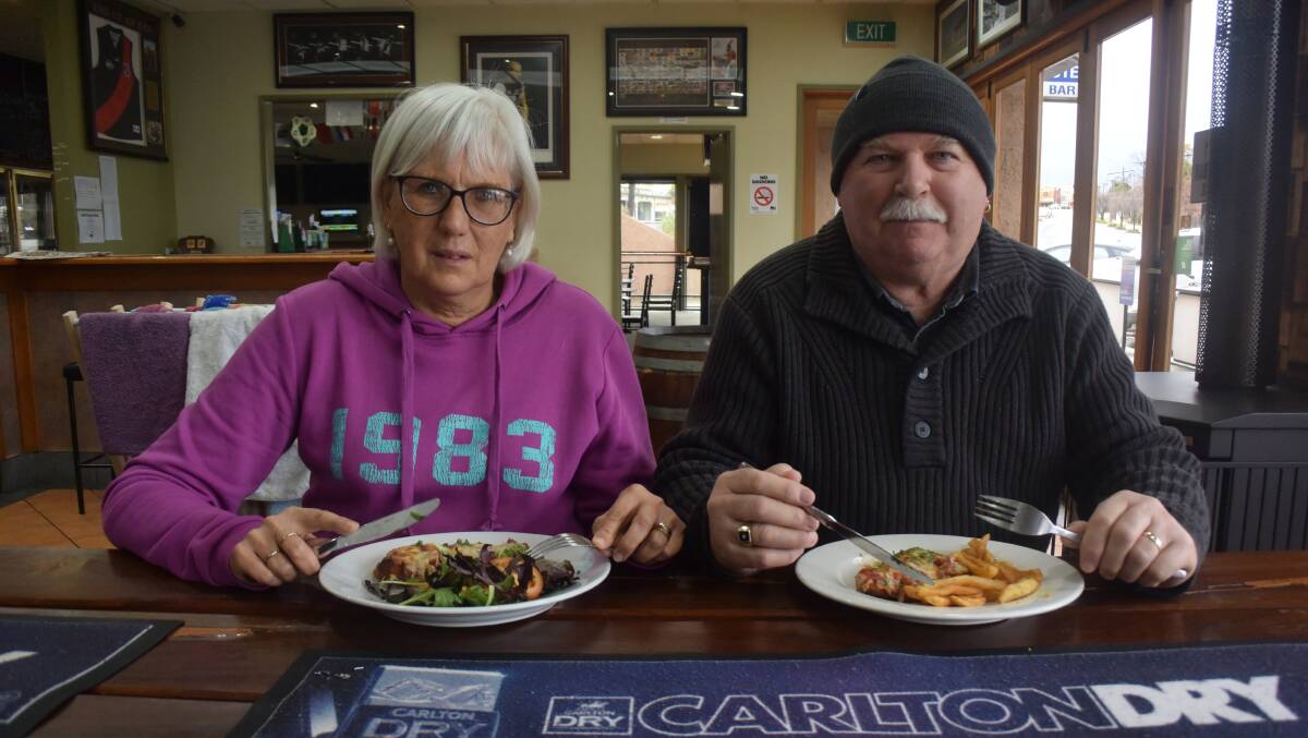 PARMA FOR A FARMER: Sue and Allan Jones tuck into a parma at the Gift Hotel in Stawell on Monday to support farmers who are experiencing drought conditions. The hotel is just one of the many venues supporting farmers. Picture: ALICE RENNISON 