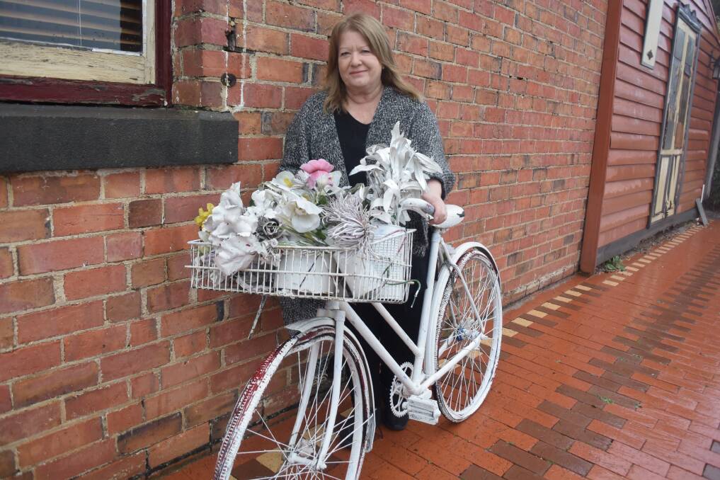 ARTISTIC: Salingers cafe owner Sandy Friend with one of her iconic bikes. Picture: ALICE RENNISON 