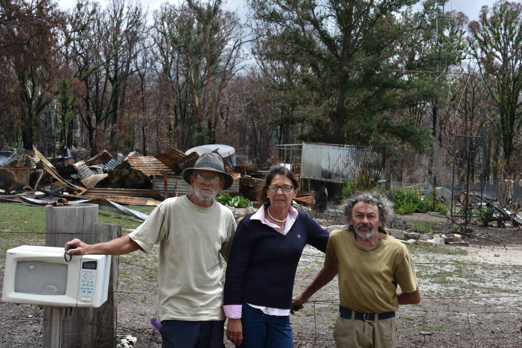 Thomas Eveans (left) with Richard Cork (right) and Glen Innes Severn councilor Diane Newman (middle). Thomas' ruined home is in the background. 