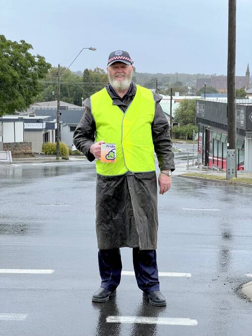 Henry Rolph braves the cold and rain to collect donations on Good Friday. Picture by Ben Fraser