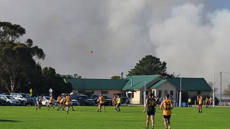 Stubble burn offs created a surreal backdrop at the games between Woorndoo-Mortlake at Tatyoon on Saturday, April 20. Picture by Ben Fraser