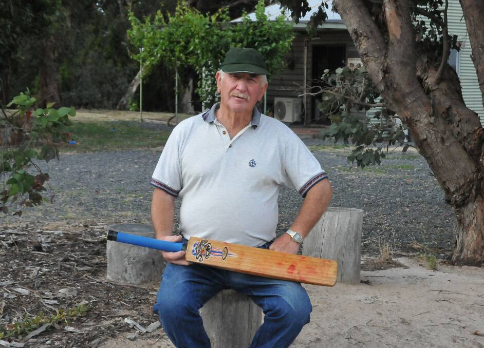 PASSIONATE: Pomonal Cricket Club's Jim Jenkinson with a bat he received after losing his home and possessions in a bushfire in 2006. Picture: CASSANDRA LANGLEY