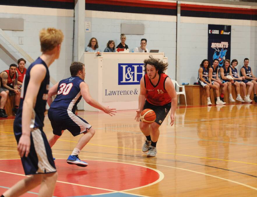 ON THE MOVE: Redbacks' Josh Fiegert gets the ball under control as he looks for options towards the basket against Horsham. Picture: CLINT KING