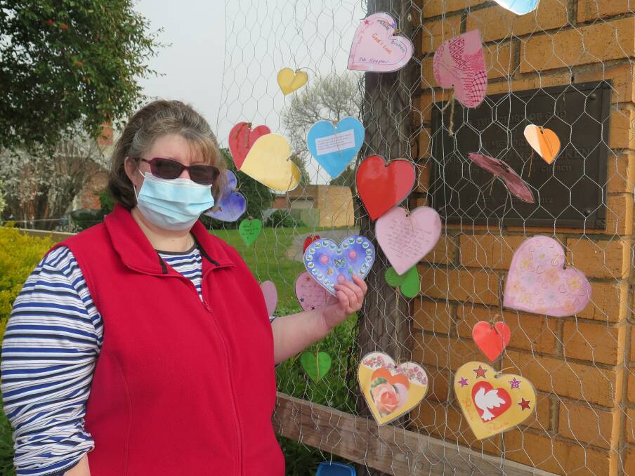MESSAGES OF THANKS: Stawell Uniting Church community art program coordinator Sue Huddleston hangs another heart of thanksgiving. Picture: CONTRIBUTED 
