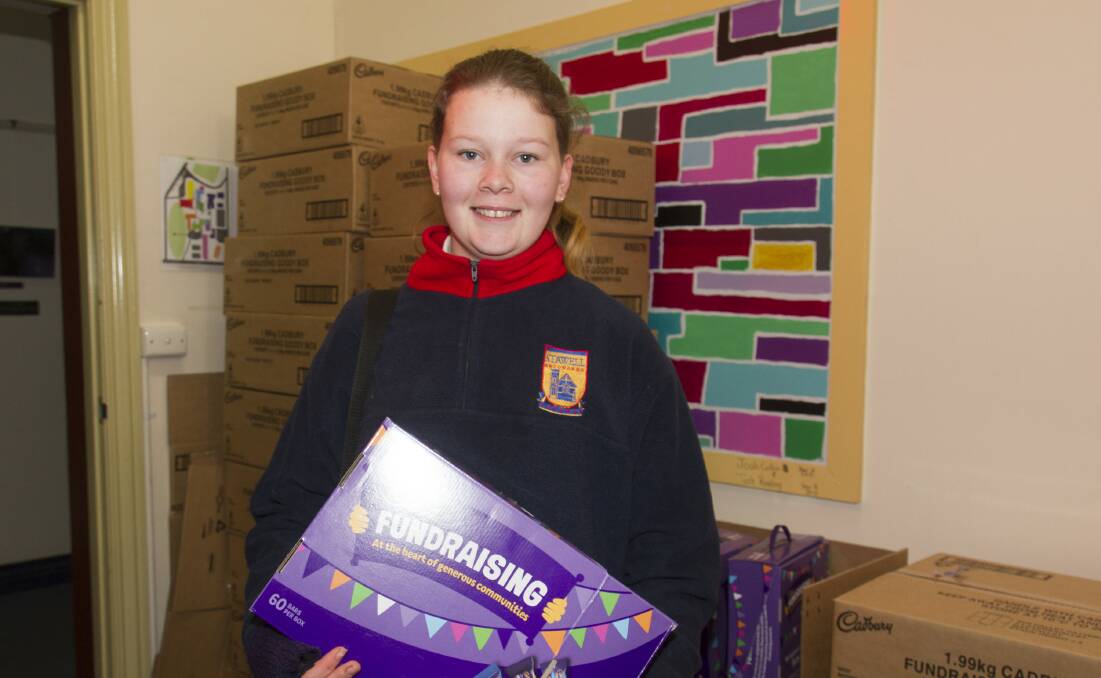 Charlotte has a mountain of chocolate to sell for the fundraiser. Picture: PETER PICKERING