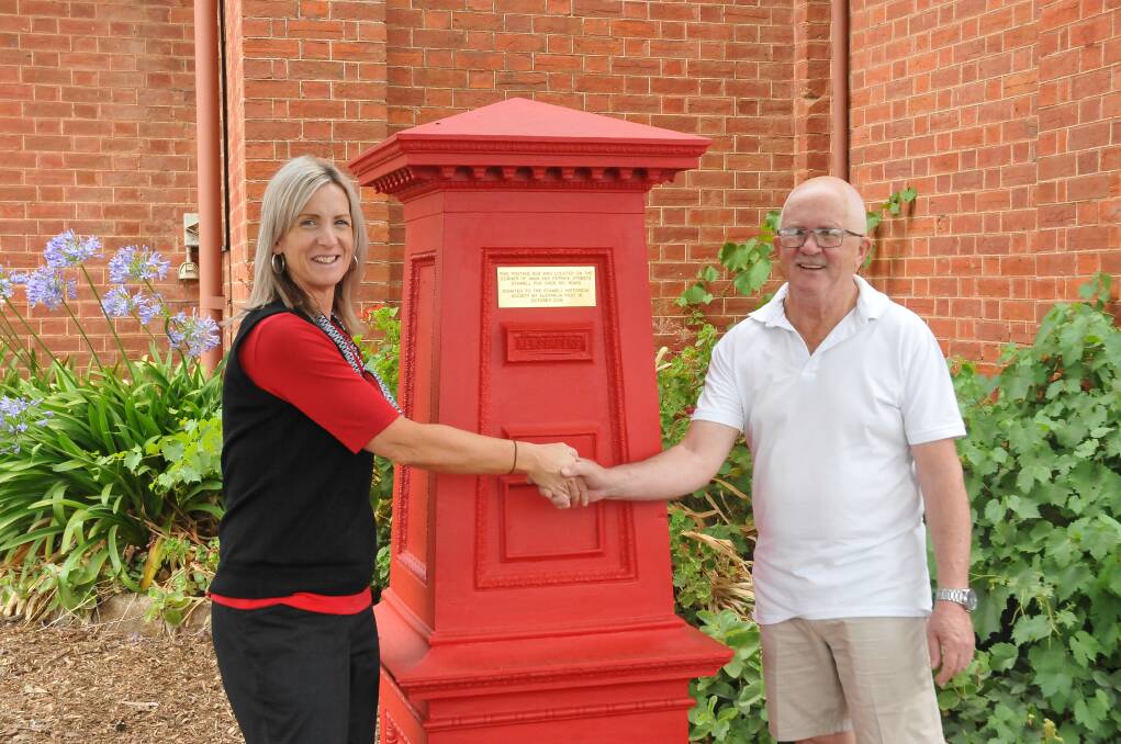ALL SMILES: Australia Post's Kylie Adamson and Stawell Historical Society's Greg Robson with the post box. Picture: CASSANDRA LANGLEY