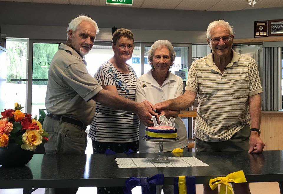 CELEBRATION: Four of the seven life members of the Stawell Bowling Club; Barry Werry, Marg Puddy, Rita Pyke and Ray Pyke cutting the cake. Picture: ELLEN WERRY