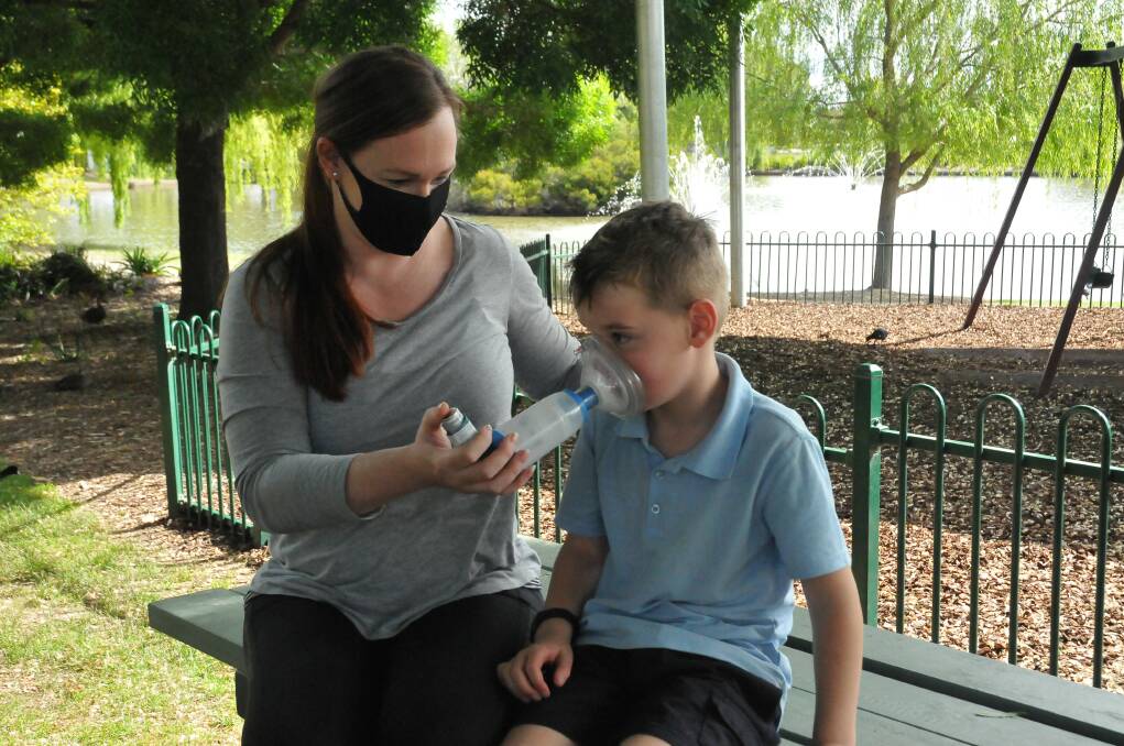 MANAGING ASTHMA: Amy Yole and son Blayze Kenny demonstrates the use of his asthma medication which includes a preventative dose. Picture: CASSANDRA LANGLEY