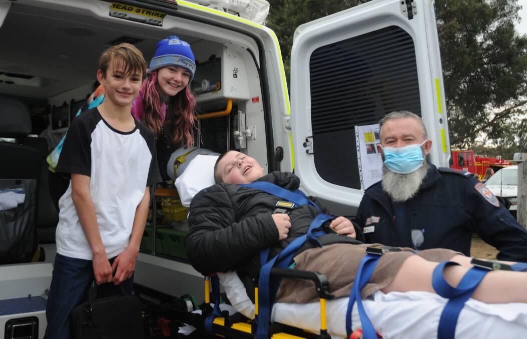 TESTING IT OUT: Students Jack, Chelsea and Kirby get an insight into life as a paramedic from Tony Colson.