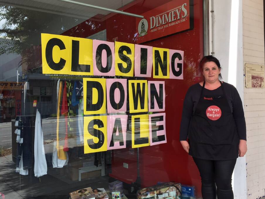 FAREWELL: Ararat's Dimmeys store manager Lisa Townsend regretfully placing the sign in the window.