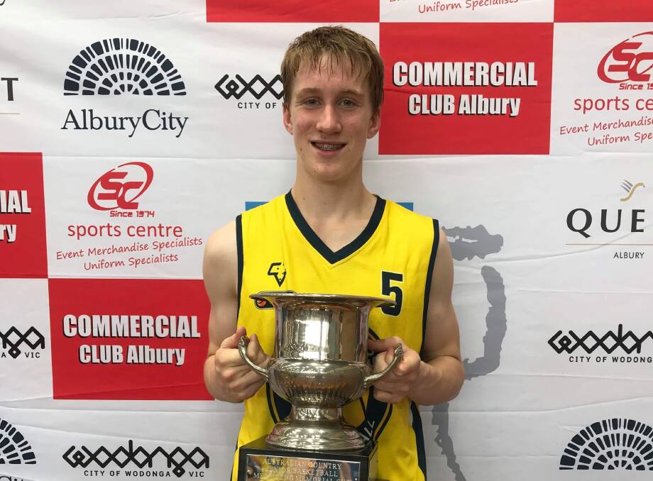 NATIONAL SUCCESS: Victoria Country's Fletcher Burger with the Australian Country Junior Basketball under-16 cup. Picture: CONTRIBUTED