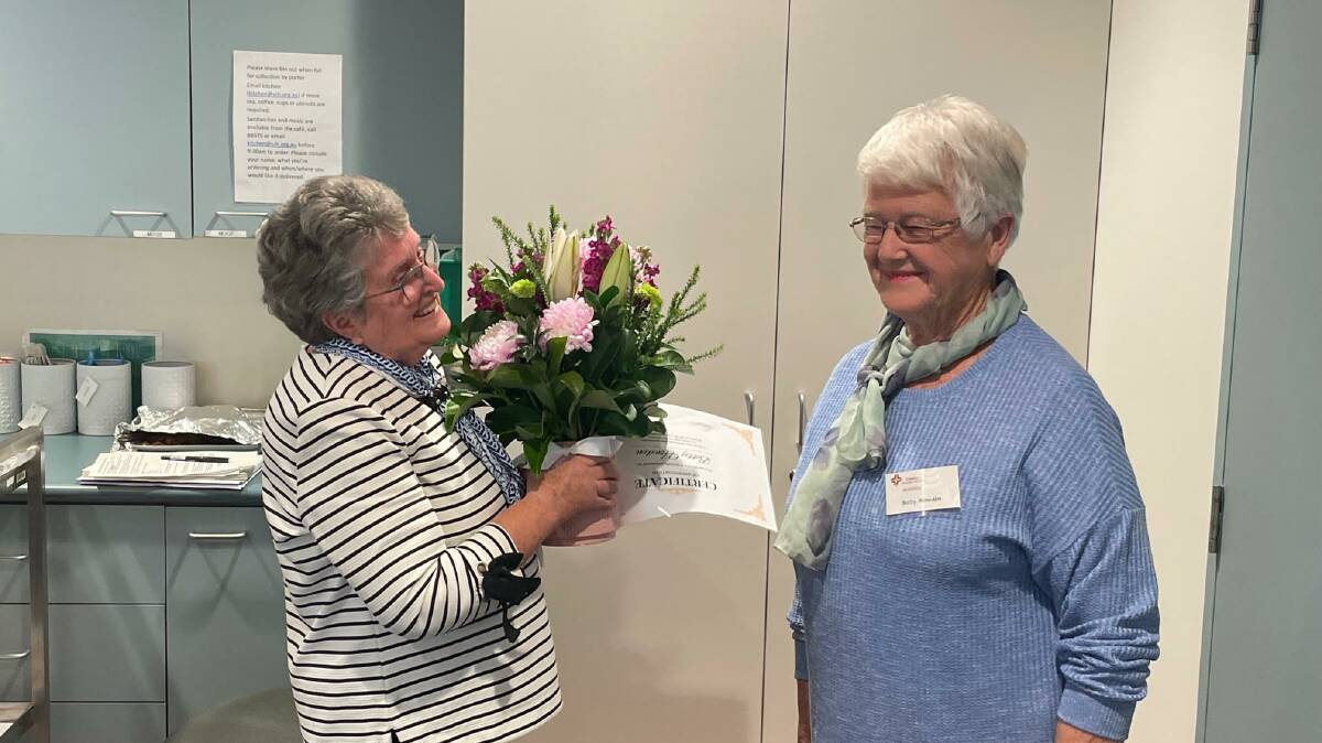 THANK YOU: Stawell Hospital Ladies Auxilary president Pam Byron presents flowers and a certificate to retiring member Betty Howden. Picture: CONTRIBUTED