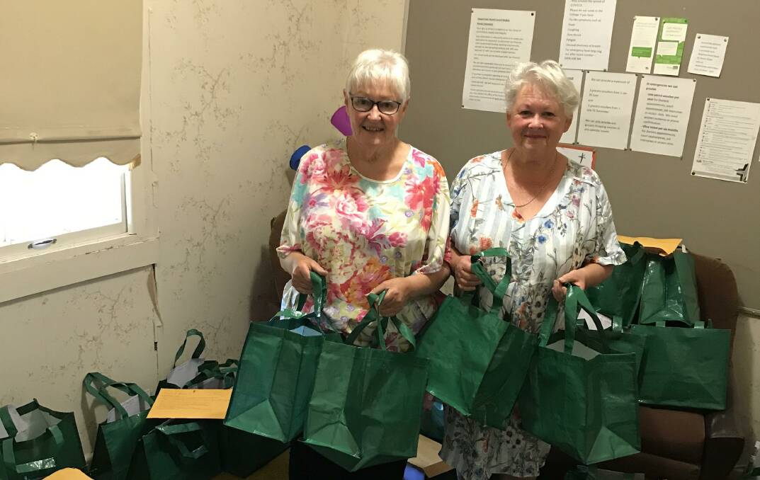 HELPING HANDS: Jo Bertram and Liz Monaghan helping to pack the Stawell Interchurch Council welfare Christmas distribution to those in need in the Stawell district. Picture: CONTRIBUTED