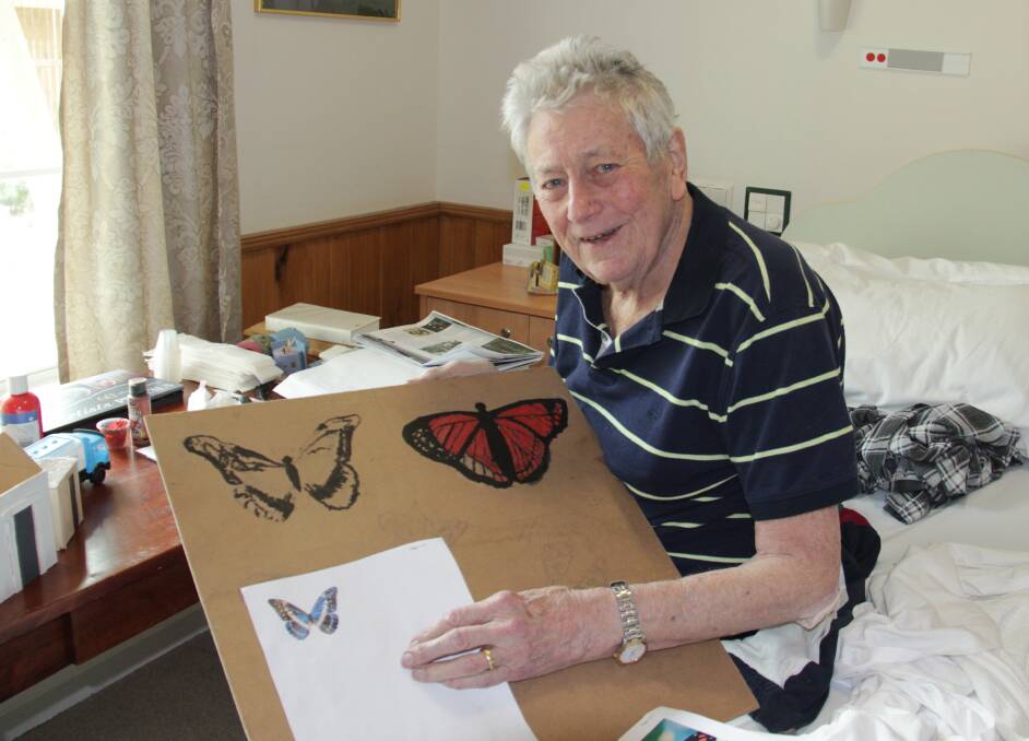 Ian Leslie at work painting butterflies.