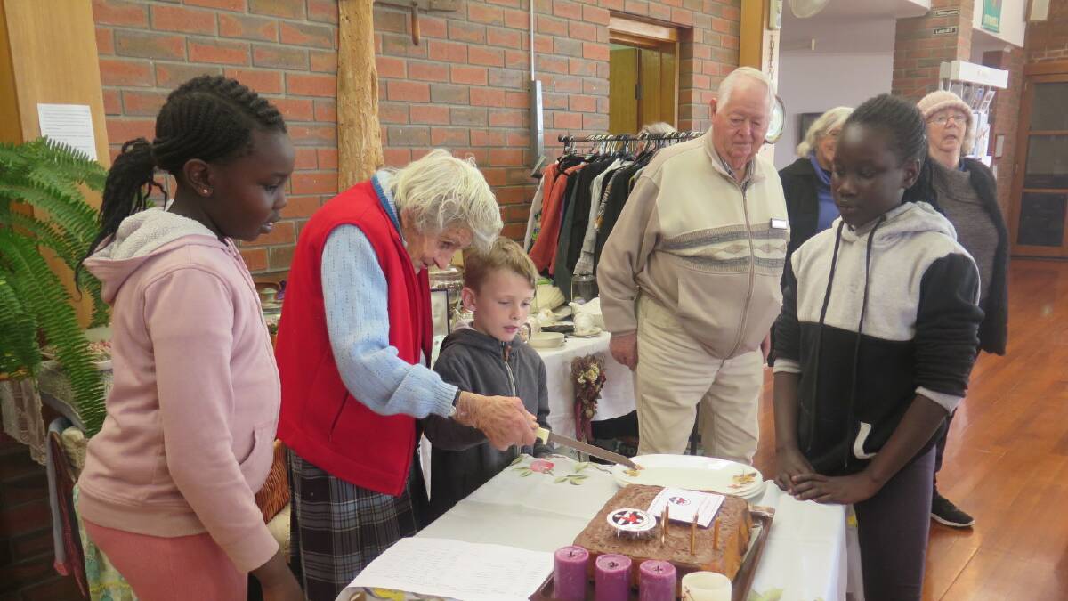 CELEBRATION: Akwual Kur, Elva Raggatt, Nate Carter, Sunday Kongor, watched by Bill Byron cut the cake at the celebrations. Picture: CONTRIBUTED