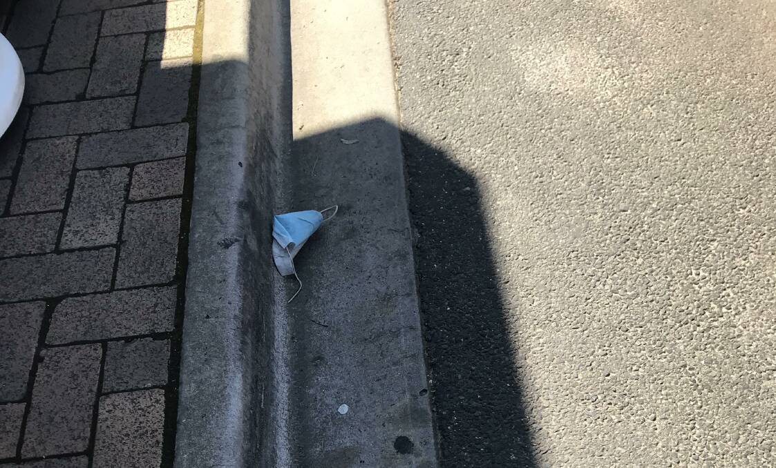 LEFT IN THE STREET: A mask found lying in the gutter on Main Street, Stawell on Sunday. Picture: CASSANDRA LANGLEY