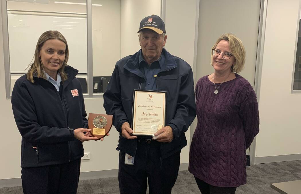 VOLUNEER: Greg Fithall's life membership is presented by CFA CEO Natalie McDonald and VFBV vice president Samantha Rothman. Picture: CONTRIBUTED