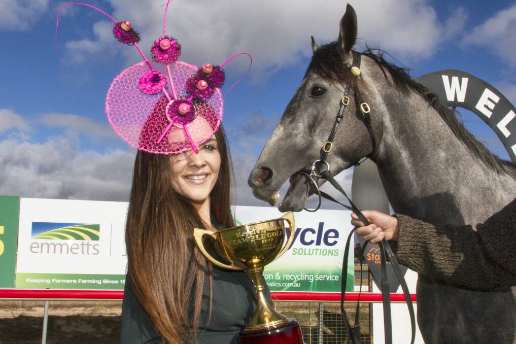 FASHIONS ALL ROUND: TKO Racing's Revlis gives Madi Deutsher some tips for the races as she prepares for the 2019 fashion on the fields events. Picture: PETER PICKERING