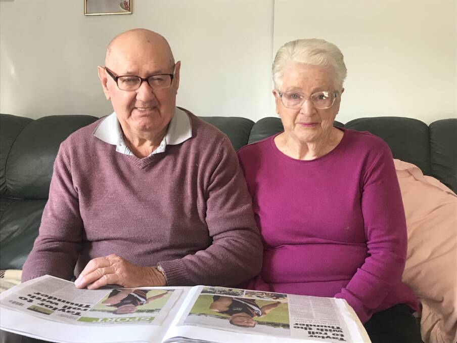 Geoff and Gwen Dunn with their scrapbook on grandson Ben Taylor's career. Picture: CASSANDRA LANGLEY