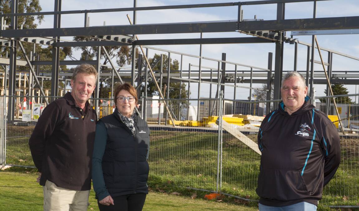 PROGRESS: Swifts' Robert and Deb Carey looking at the progress of the new building with club president Ian O'Donnell at North Park. Picture: PETER PICKERING