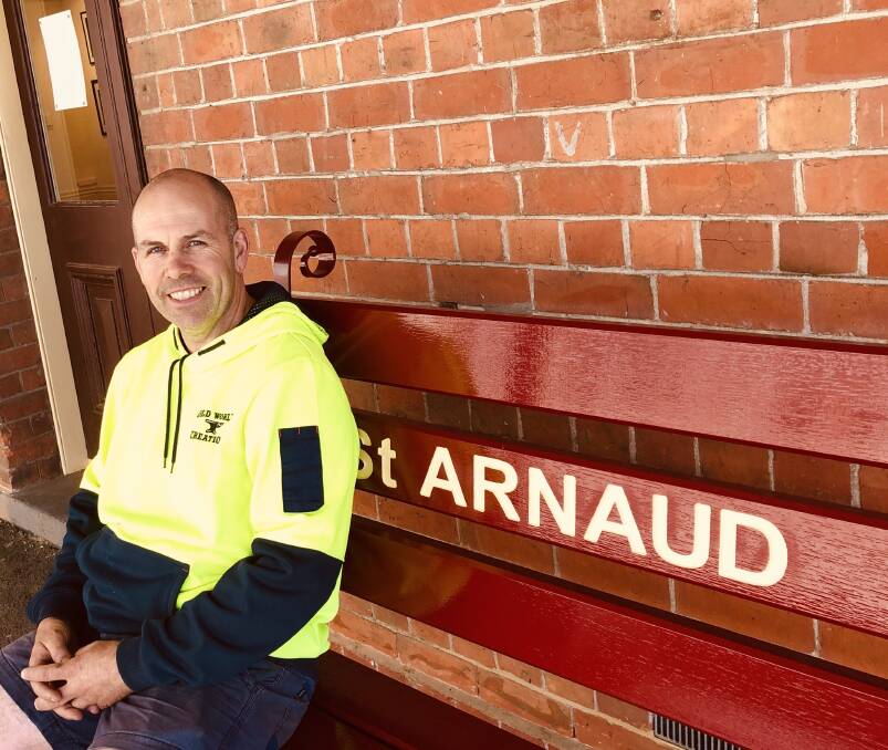 INSTALLATION: Tony Raeburn seated on the St Arnaud Railway Station platform on one of his raillery benches. Picture: SUPPLIED