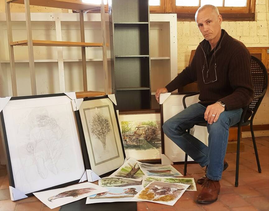 ARTWORK: Artist and illustrator Shane Boland with a collection of his works for the hobbies, craft and collectibles exhibition. 