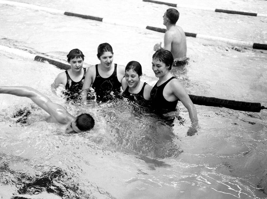 Australian swimmers Elizabeth Fraser, Dawn Fraser, Sandra Morgan and Beverly Bainbridge make room for teammate Graham Hamilton during training at the 1956 Melbourne Olympics. Picture: Frank Burke