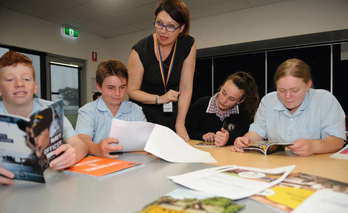 CHOICES ABOUND: Horsham College careers adviser Caroline O’Donnell with Year 8 students looking at careers brochures. Picture: CARLY WERNER