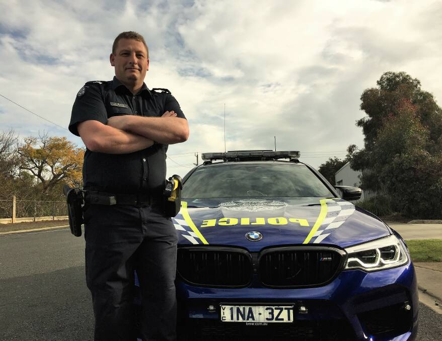 POLICE PRESENCE: Senior Constable Jason Brown with the BMW on loan for Operation Argus. Picture: JESSIEANNE GARTLAN. 