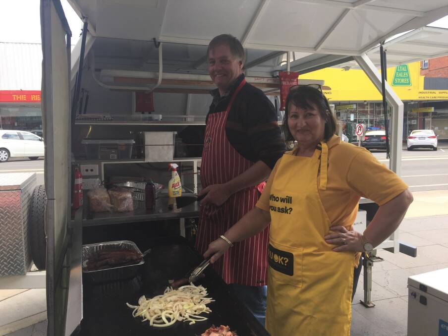 SUPPORT: Lions Club of Ararat members Rosi Sanders and Terry McInnes cook a barbecue on Ararat's Barkly Street for R U OK? Day.