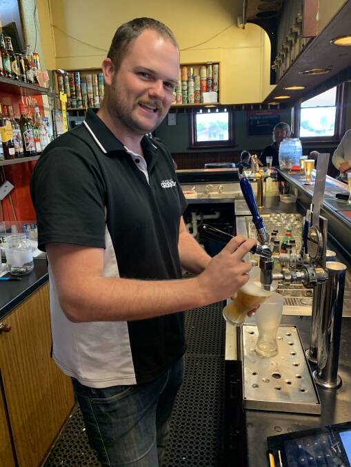 Bar tender Harry Swaine pulls beers for thirsty, and generous, patrons. Picture: CONTRIBUTED. 
