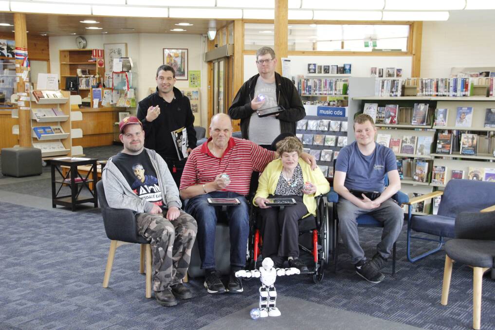 DIGITAL AGE: Eric, Callum, Phil, Thomas, Christine and Brandon from Pinnacle enjoyed their time with the robots at Stawell Library on Tuesday. Picture: LACHLAN WILLIAMS