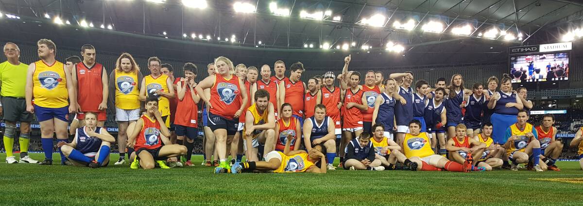 WHAT A NIGHT: FIDA players from across the state at Etihad Stadium for their half-time appearance at the EJ Whitten Legends game. 