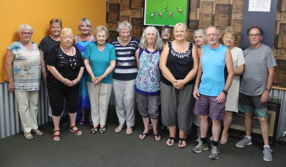 Stawell Regional Health's Noelene Gration and Eventide Homes chief executive Sue Blakey (far left) with Bookworm Gallery volunteers. Picture: LACHLAN WILLIAMS