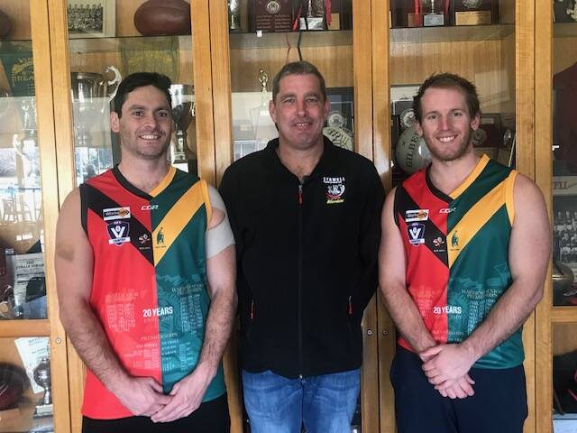 CELEBRATING HISTORY: Stawell Warriors current day players Damian Joiner (coach) and Cam Kimber flank president Tim Williams is specially designed playing tops.