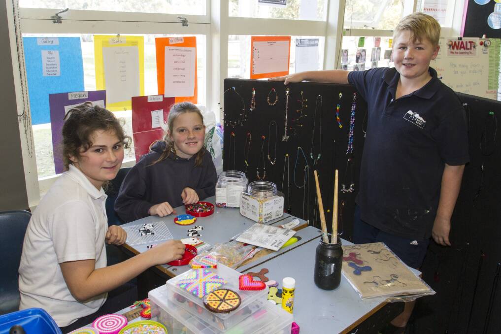 CREATIVE: Stawell West Primary students Annie and Jacinta busy preparing for their school's mini market on Wednesday, June 28. Picture: Peter Pickering
