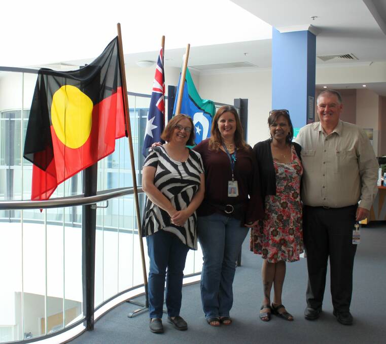 ALL SMILES: Suzie Hamilton, Veronica Pascall, Jo Clack and Grampians Community Health chief executive Greg Little beside the new flag display. 
