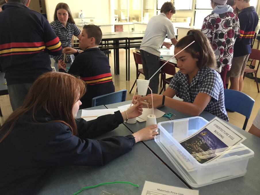 CONCENTRATION: These Stawell Secondary pupils are trying to construct a tall structure using limited materials at the school's science workshop. Picture: Anthony Piovesan