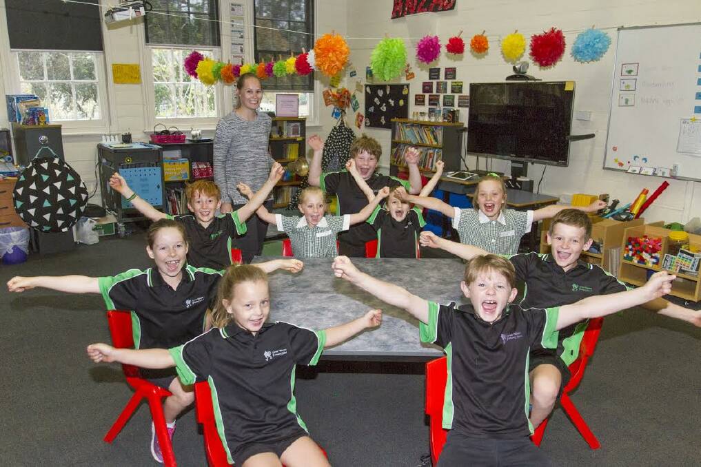 ACHIEVEMENT: Teacher Kate Hammond and her pupils rejoice over Great Western Primary's latest significant milestone. Picture: Peter Pickering