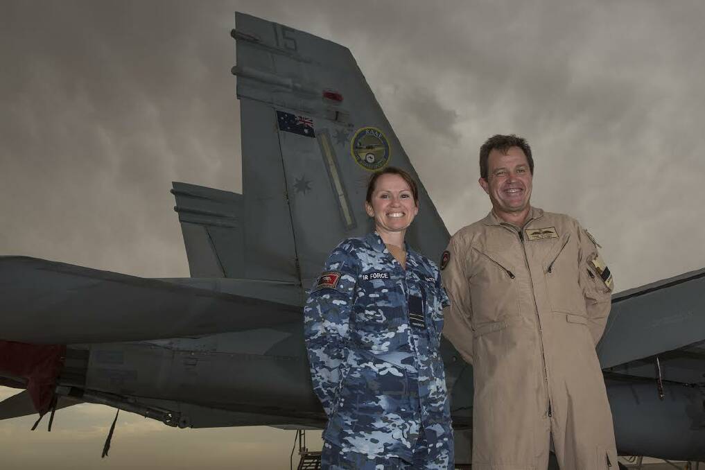 COMBAT: Flight Lieutenant Andrea hateley and Commander Air Task Group, Air Commodore Mike Kitcher stand in front of an F/a-18 Hornet.