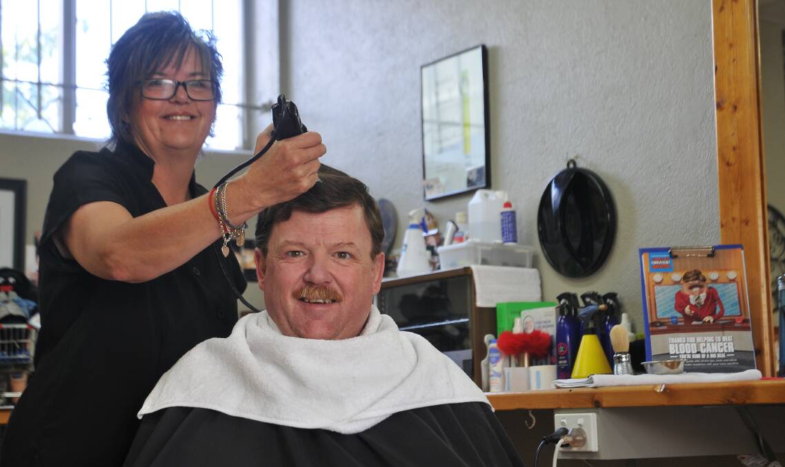 SUPPORT: Tracey Joiner from TJ's Barber Shop is going through a practice run before she shaves David Brown's hair for the World's Greatest Shave in March. Picture: Anthony Piovesan