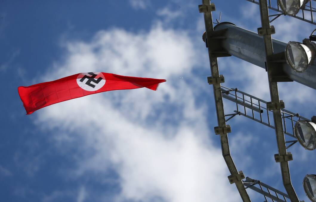 OFFENSIVE ACT: A Nazi flag is seen flying from the top of a light tower at Robertson Oval on Monday afternoon. Picture: Emma Hillier
