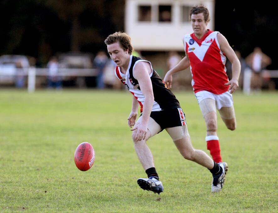 Shayne Williams chases after the footy. Williams booted 74 goals across the decade.
