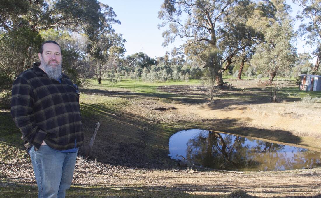 Brett Tunstall next to one of his dams on his Great Western property. Picture: PETER PICKERING