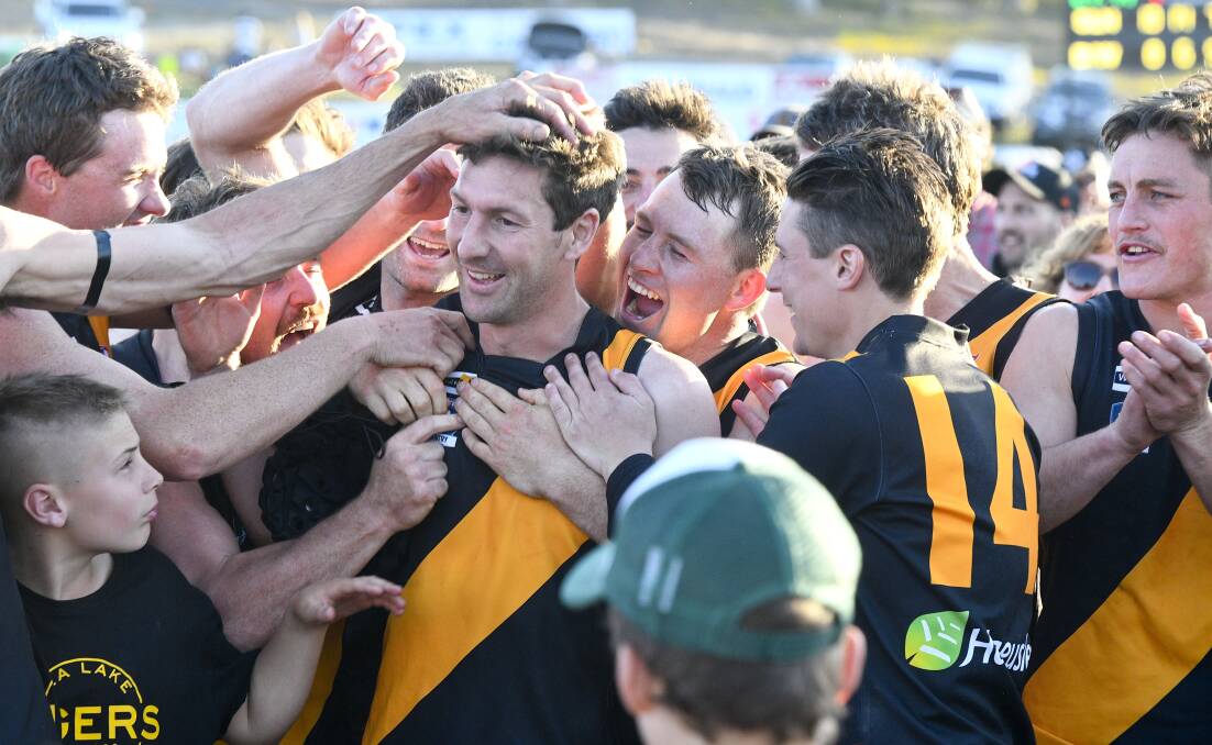 Jacob Schaper (number 14) celebrates with his teammates after Sea Lake Nandaly claimed the NCFL premiership. Picture: NONI HYETT/BENDIGO ADVERTISER