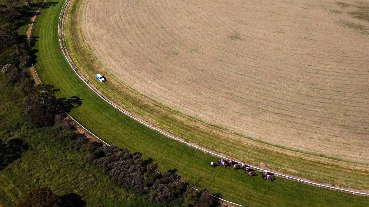 BIRD'S EYE VIEW: Horses run around the track at Mortlake for race seven. Picture: Morgan Hancock