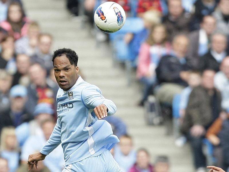 Racing Murcia have announced the signing of Joleon Lescott (l) without the defender knowing.