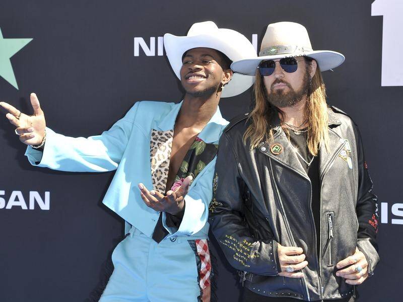 Lil Nas X (L) and Billy Ray Cyrus's (R) hit song Old Town Road has spent 17 weeks as Number One.
