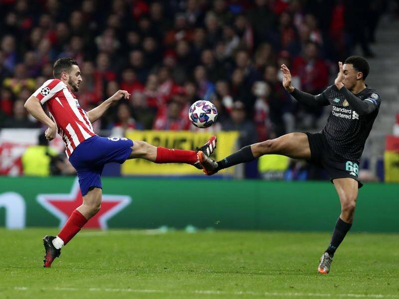 Atletico's Koke (l) and Liverpool's Trent Alexander-Arnold fight for the ball in the host's 1-0 win.